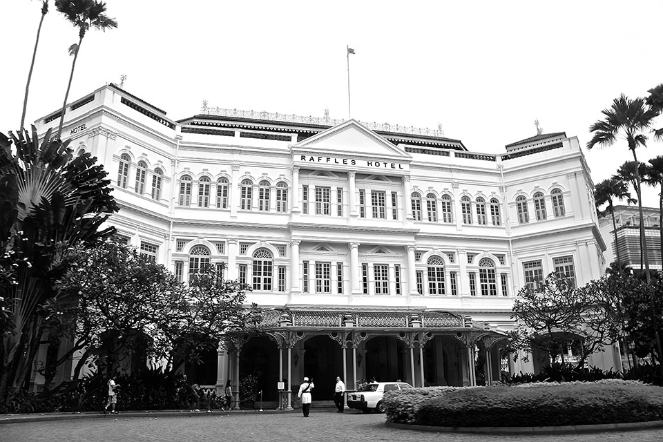 Bret Steiman. Guard in formal attire walks into World Famous Raffles Hotel