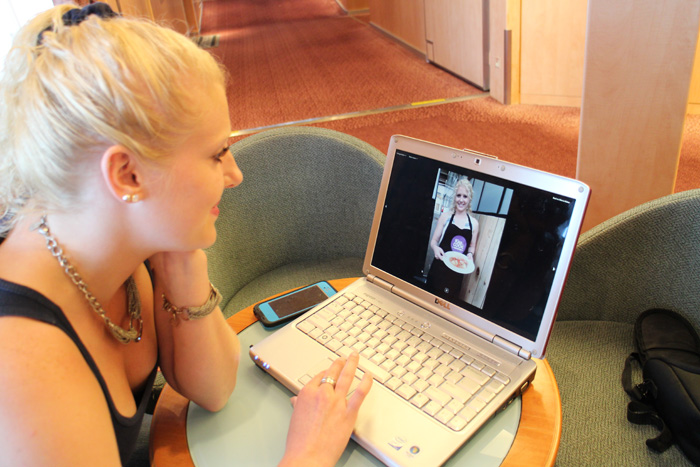 Marquette Hovan works on her video journal that includes this photo of her at a cooking class field program in Lisbon, Portugal.