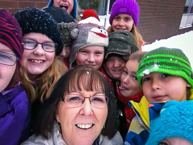 Bonnie Goertz, an elementary school teacher in Wisconsin, surrounds herself with her students to say hello to Lizzie Narlock, a Fall 2014 voyager. Goertz participated in the program in Fall 2001 when Narlock was in her class and her older sister sailed around the world. Photo submitted by: Lizzie Narlock