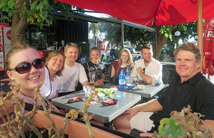 (From left to right), Allie Krumel, Brenda Krumel, James Crowell of University of San Diego, Kayleigh Corrigan, Melanie Spurling, Isaac Kitching of Georgia State University, and Rich Krumel taste some local cuisine an outdoor café in Civitavecchia before on-ship time.