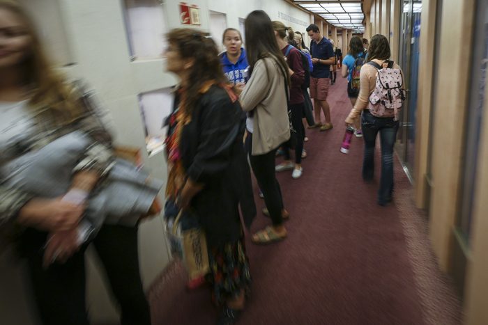 On the first day of the semester, students crowd the hallways as they line up for the bookstore and pass by headed to class.