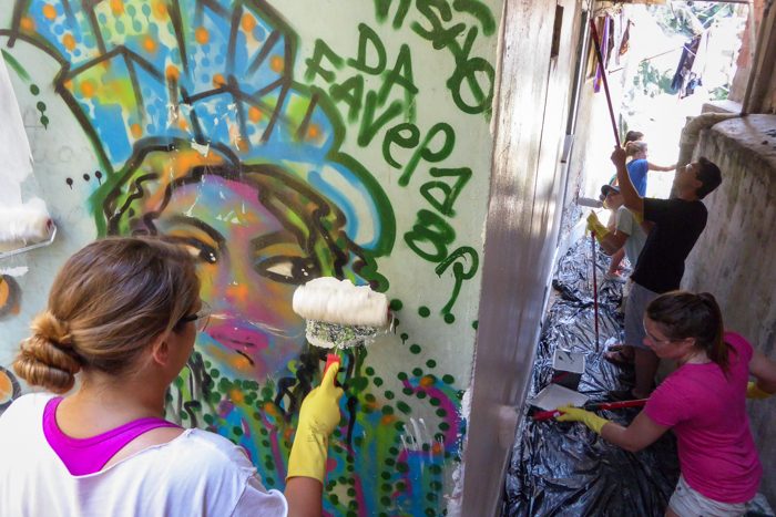 Students lend a hand in painting local residents' homes in the Santa Marta community.