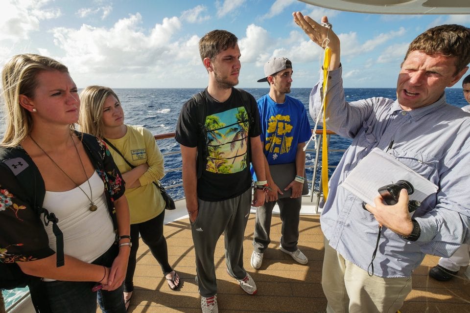 Professor Falk Huettmann explains to Fall 2014 students how the Argo floats instrument will enter the water as the box dissolves.
