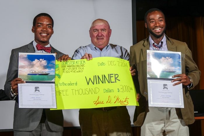 Team Owa, comprised of students Jonathan Moses (left) and Adam Odomore (right) accept their $3,000 check from professor Brad Brown.