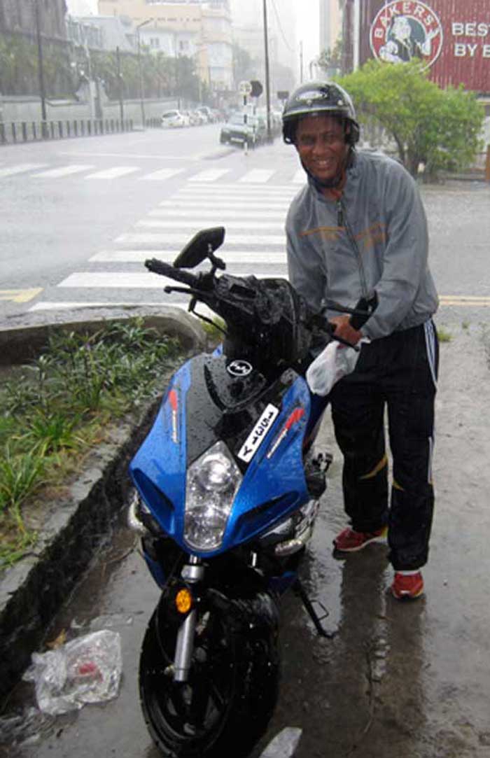 Abdoullah-with-his-motorbike-in-the-rain