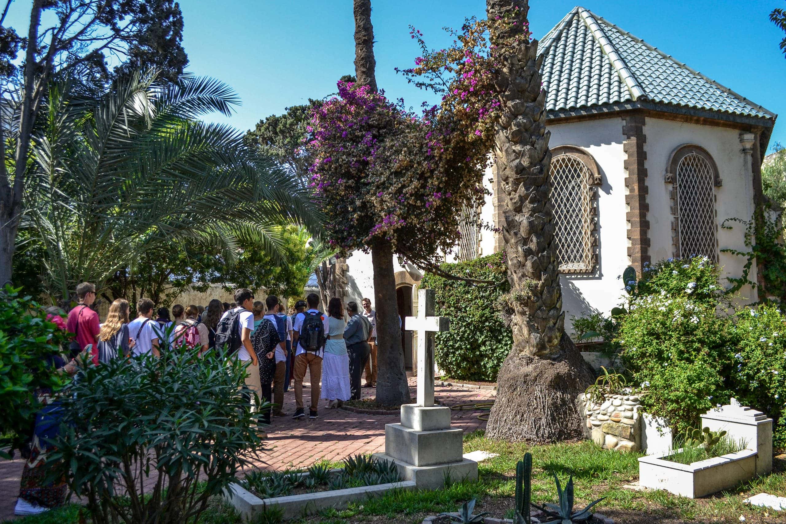 Exploring the surrounding cemetery, world religion students study the role of Christian worshippers in a predominantly Muslim country.