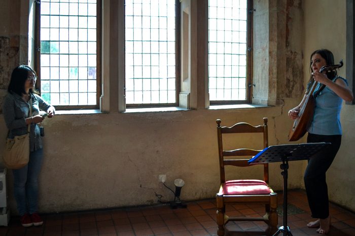In the Malbork Castle waiting room, Vanessa Yuan of Cabrini College enjoyed the music that helped entertain guests as they prepared to see the Grand Master.