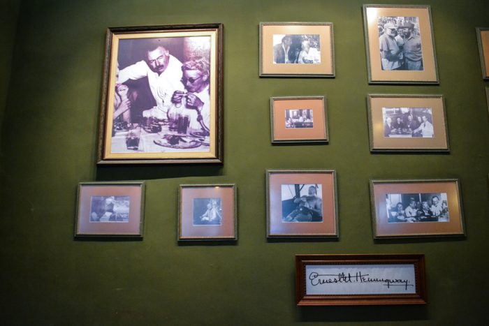 In the lobby of Hotel xx, photos of Hemingway hang on the wall in celebration of the time he spent there.