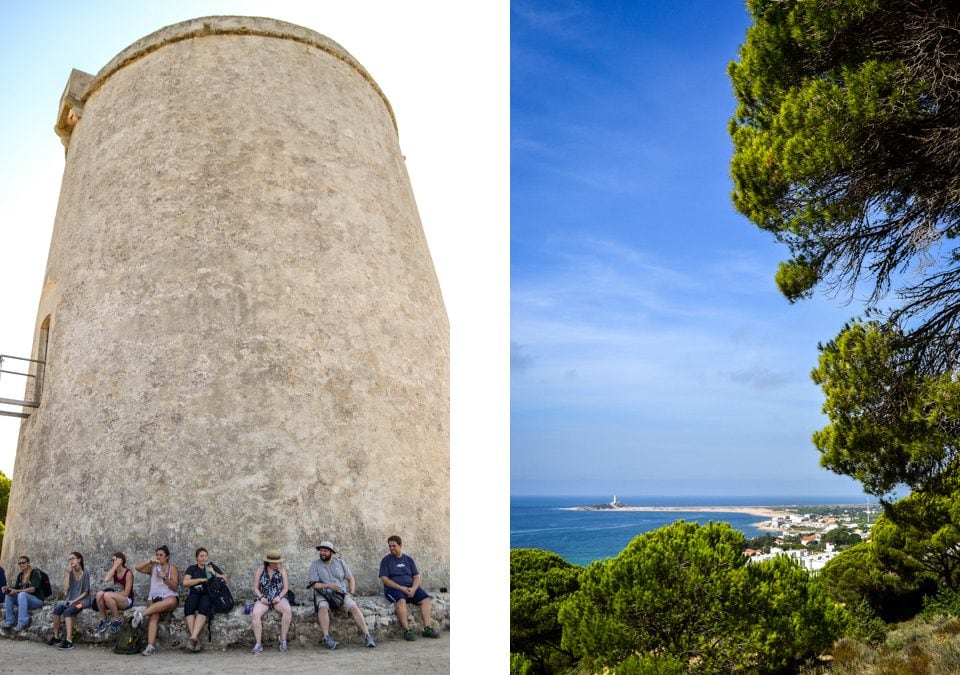 Left: The group rests under the first round tower they encountered along the way. These towers were commisioned by the King in the x century to protect the coastline from the Moors. Right: The Trafalgar Lighthouse comes into vision for the first time during the hike. The group then descended for the remainder of the hike to reach their intended destination. 