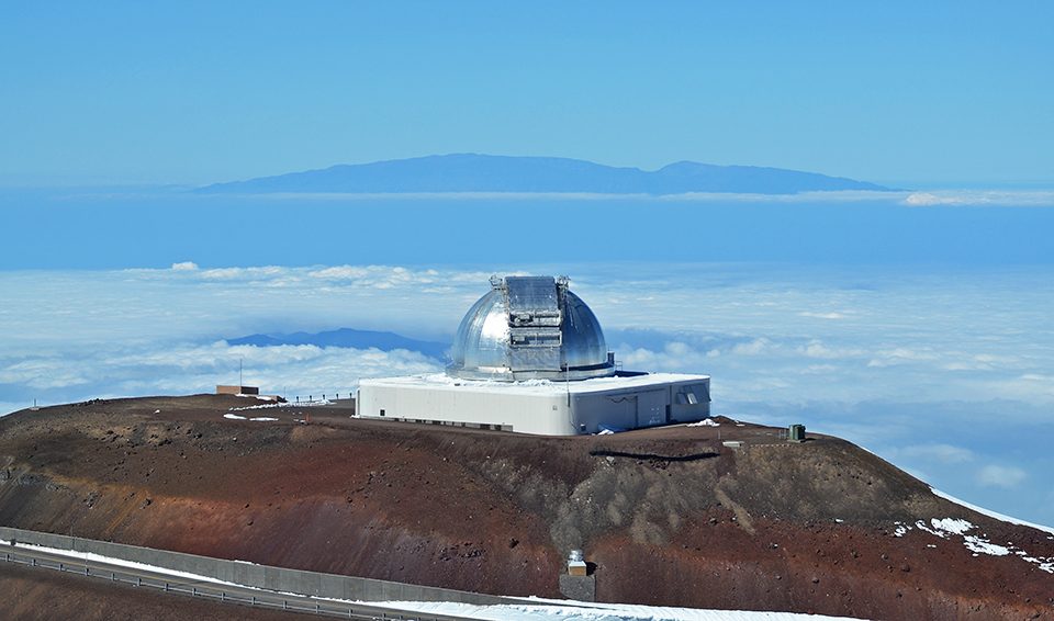 Lifelong Learner Ellen Porter from Atlanta, Georgia was lucky to make it to the summit of Mauna Kea (13,677 ft) as the road had been blocked with snow and ice until the day we arrived. There are 13 observatories on the summit, this view shows Maui in the distance.