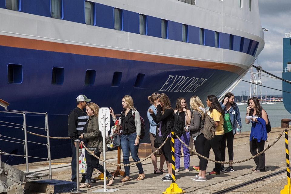 Students line up at the bottom of the gangway stairs to begin boarding the MV Explorer