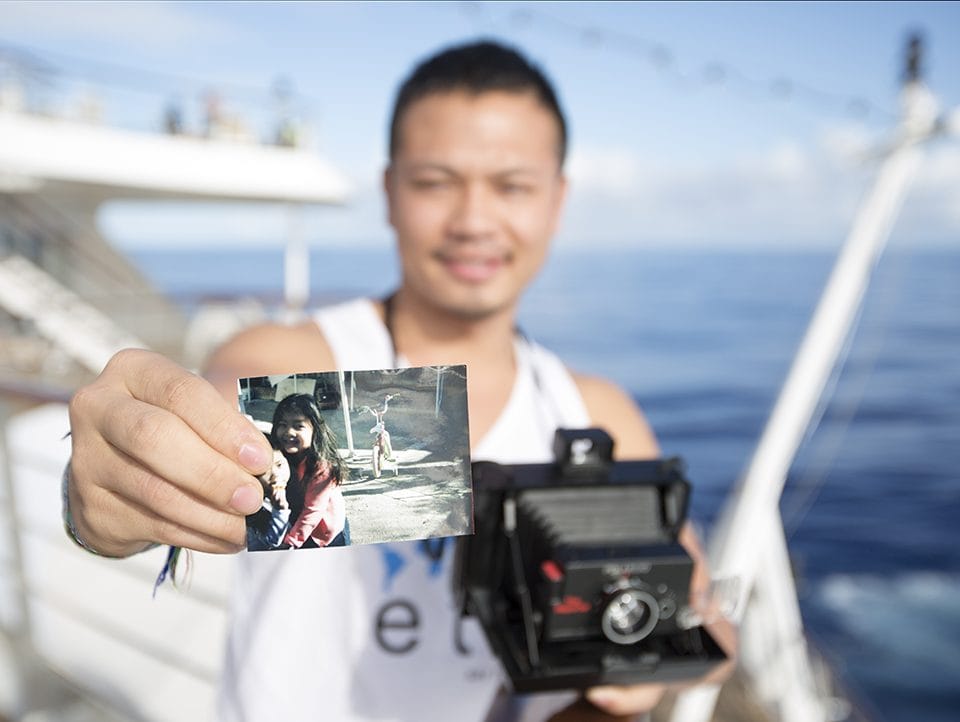 Hoang Nguyen shows a photo he took of his nieces with his Polaroid camera 