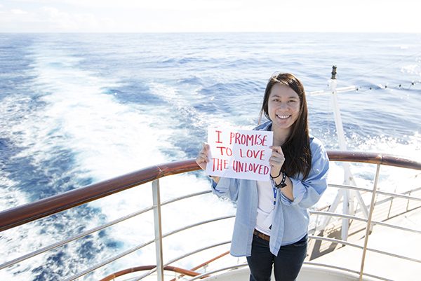 Christine Vo shows off one of her 'I Promise' signs