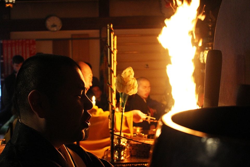 Samantha Hutchison, a student at Texas Tech University, stayed the night at Kongobuji Temple in Koyasan with a Semester at Sea field program. The group had the opportunity to watch the monks' morning prayers then go outside to see a fire ceremony. The monk in the foreground is chanting while the others are drumming and striking a singing bowl.