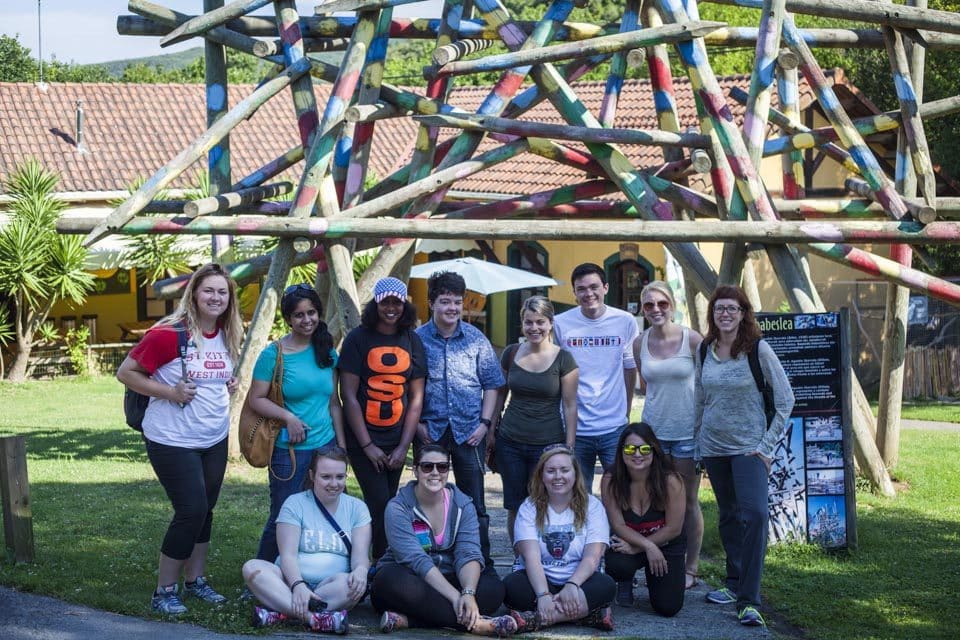 The group sits beneath the sculpture by artist Agustin Ibarrola located at the entrance of the sanctuary. The piece, donated by the artist represents a rainbow placed over a totem to protect the animals taken in against the threats of the outside world. 