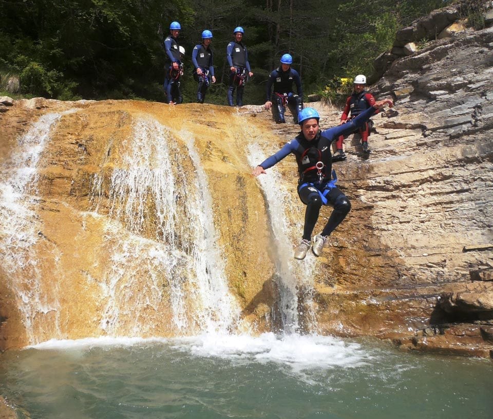 Semester at Sea student jumps off a waterfall as his companions and tour guide watch. These, as well as 35 more students and faculty, participated in the Multi-Adventure in Pyrenees field program which included white water rafting and cannoning (as seen in the picture) up in the Pyrenees Mountains. Photo by Patrick Corbett of University of Virginia. 