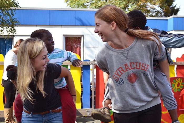 Two students gave piggy-back rides to youngsters on the playground. Laura Singer (on right) said, "None of them notice their physical differences. They were just kids."