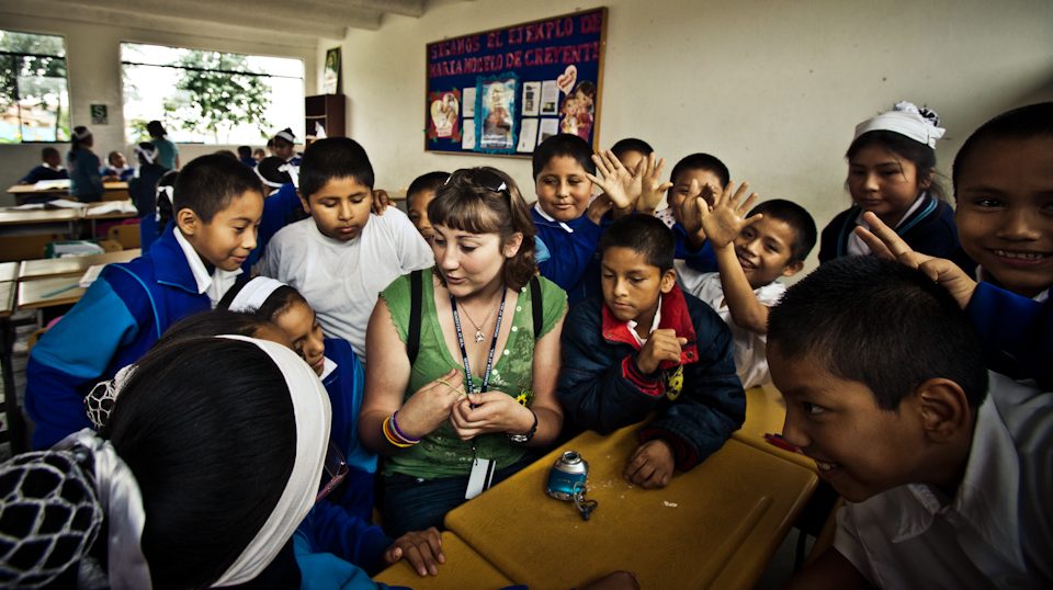 Washington State University student Megan Welsh spends time and answers all of the children's questions as they are quite eager to learn about her background.