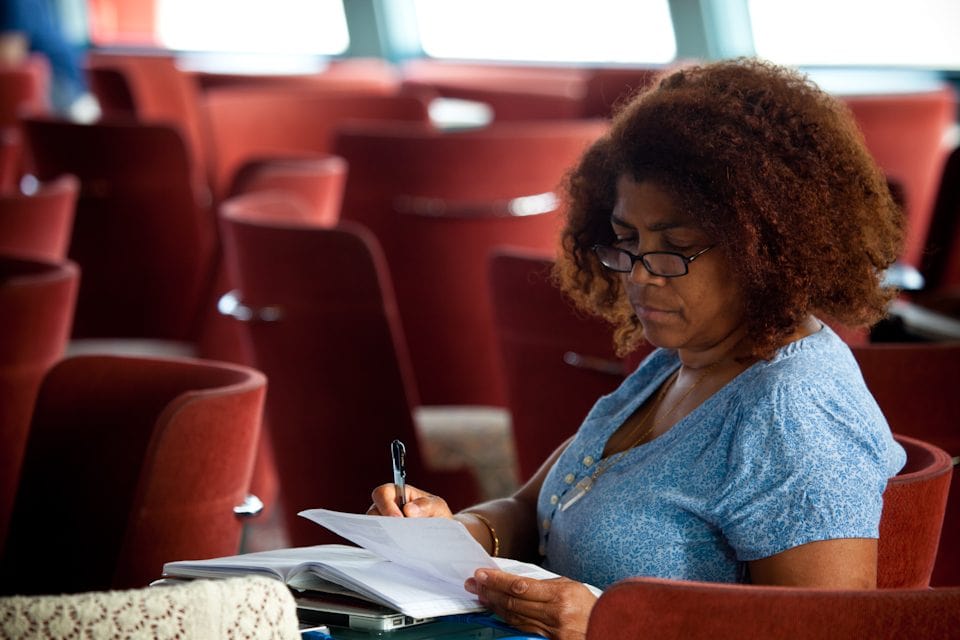 S12_Profile_Photo-3 Academic Dean Rosalyn Berne works in a common area aboard the MV Explorer.