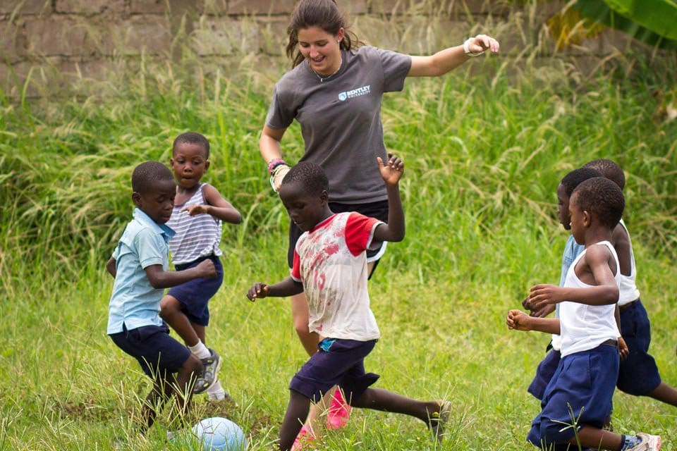 Alicia Butler, a student from Bentley University, plays a pickup game in Ghana with a One World Futbol. 