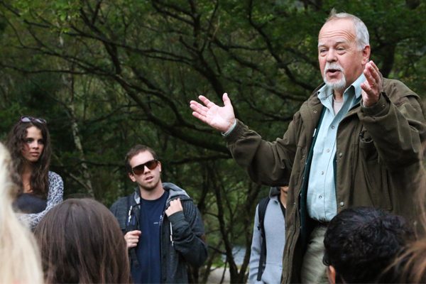 Nina Pellechio (left) of Emerson College and Kalin Hoiseth (center) of University of Colorado Boulder listen to Philip Byrne (right) tell the story of the Banshee.