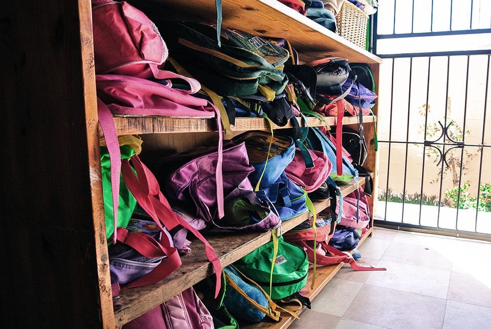 Backpacks at school in township. Photo by Cassie Carte_