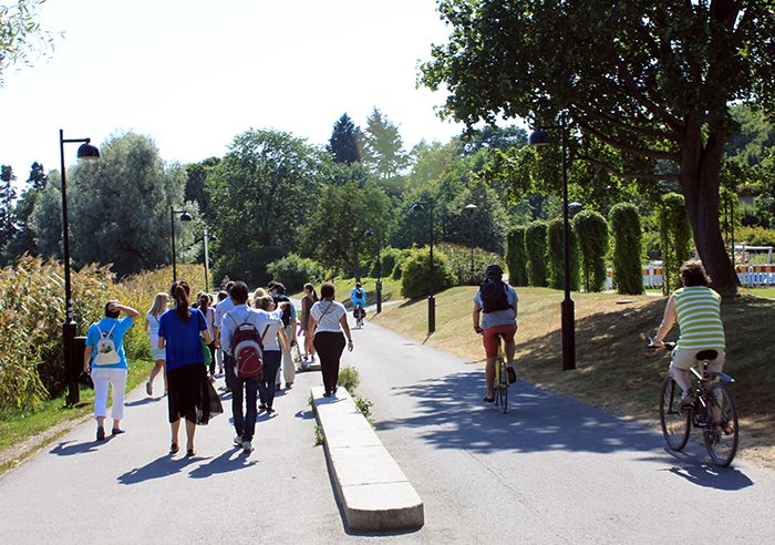 Pedestrians and cyclists share a recreation path in Helsinki's Central Park.