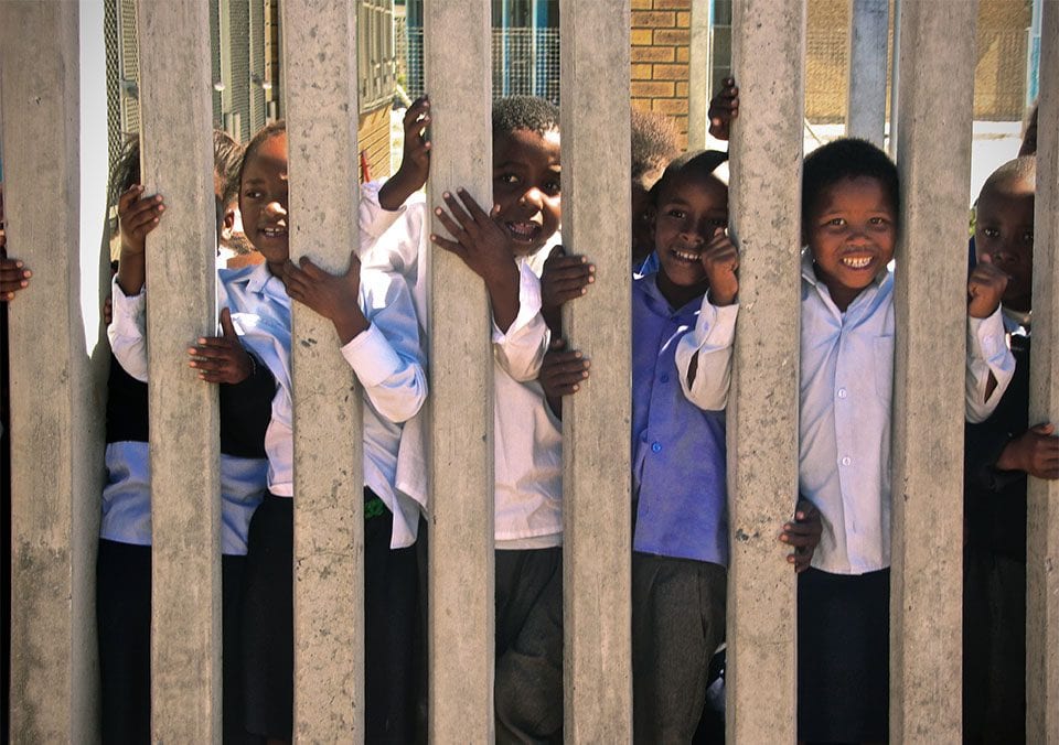 Kids who are part of the Operation Hunger program are excited to see the visitors from the Biomedical Ethics Field Lab in Cape Town. Photo by Jordan Loewe