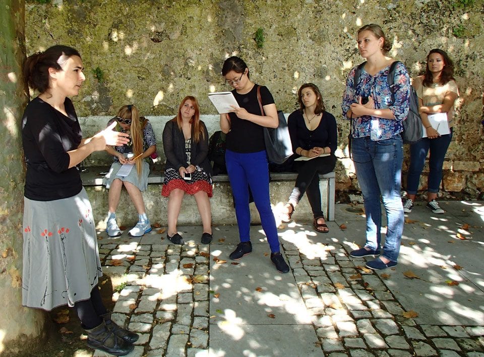 Dr. Marta Prista, a Portuguese tourism scholar who has conducted long-term anthropological research in Obidos, talks with students outside the ancient village walls.