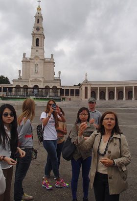 Tour guide Filomeana points out the key sights at the Sanctuary of Fatima.