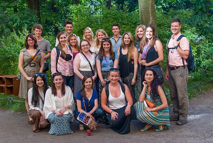 John Casteen (far right), helpful tour guide Katya Koshevatskaya (far right front) and Travel Writing students in the courtyard outside of Anna TKs home in St. Petersburg.