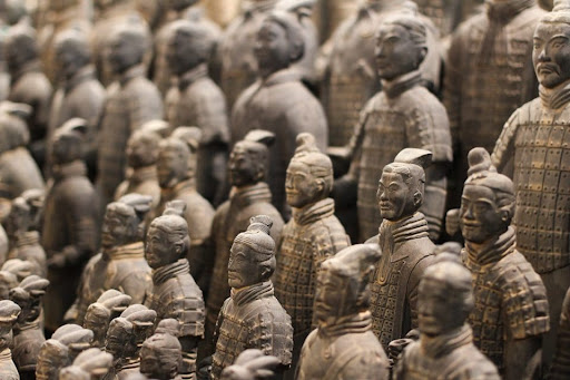 Carved stone soldiers stand in ascending rows.